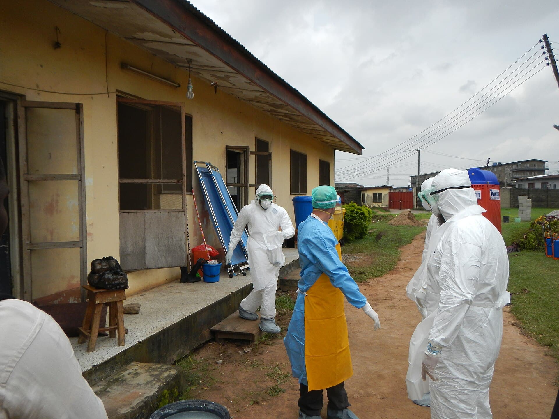 WHO workers in protective gear prepare to enter an old Ebola isolation ward in Lagos, Nigeria.